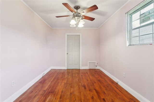 spare room featuring hardwood / wood-style flooring, ceiling fan, and crown molding