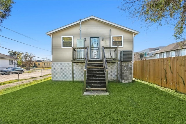 back of house featuring a lawn