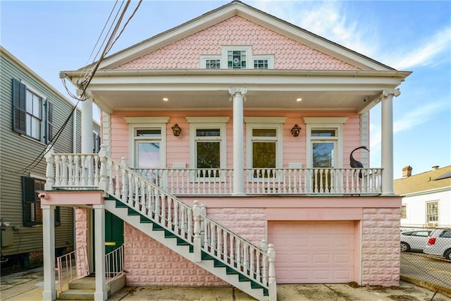 view of front of house featuring a porch and a garage