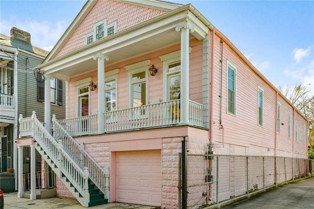 view of front of property with covered porch and a garage