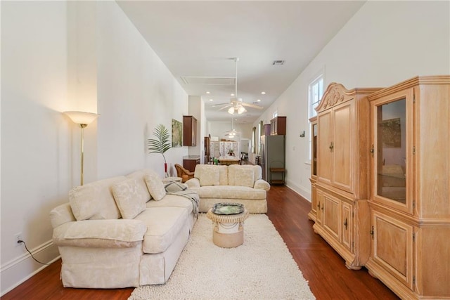 living room featuring ceiling fan and dark hardwood / wood-style flooring