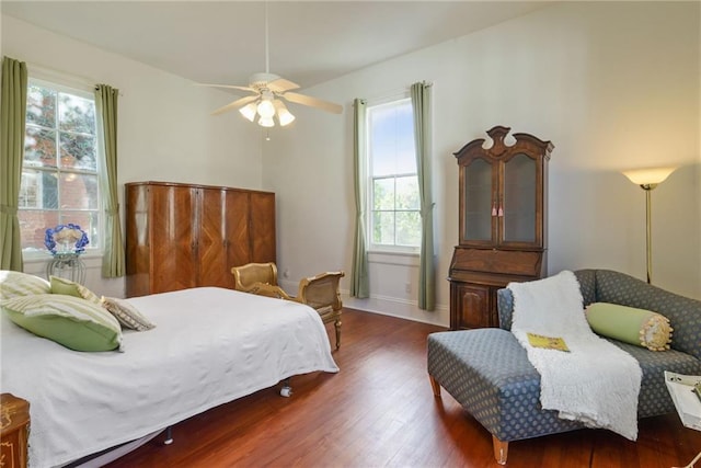 bedroom with dark hardwood / wood-style floors and ceiling fan