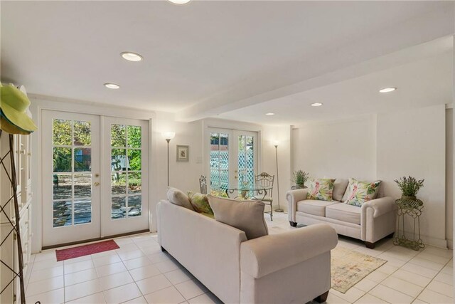 tiled living room with a healthy amount of sunlight and french doors