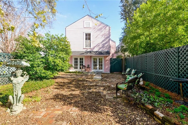 back of property with french doors and a patio area