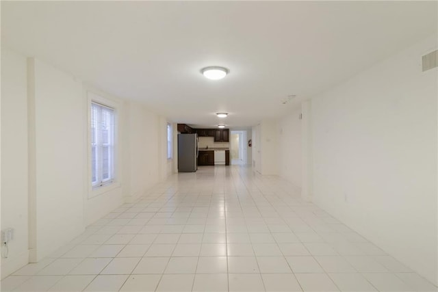 spare room featuring light tile patterned flooring