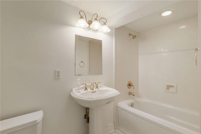 bathroom featuring shower / bathing tub combination and toilet