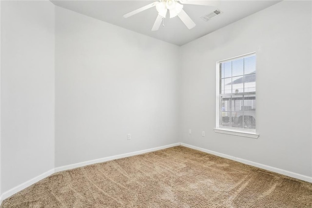 unfurnished room featuring ceiling fan and carpet