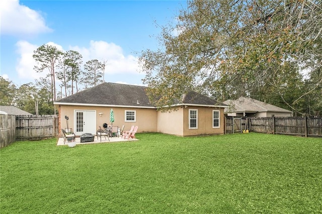 back of property with a patio, an outdoor fire pit, and a lawn