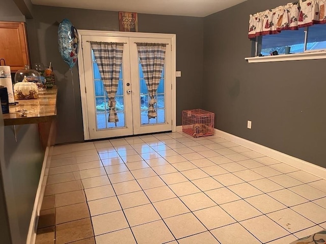 entryway with french doors and light tile patterned floors