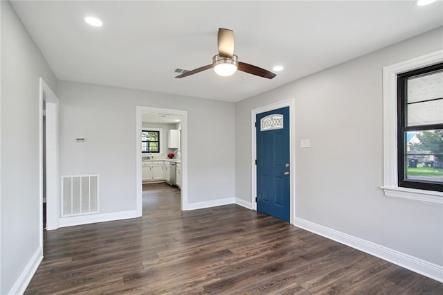 entrance foyer featuring ceiling fan and dark wood-type flooring