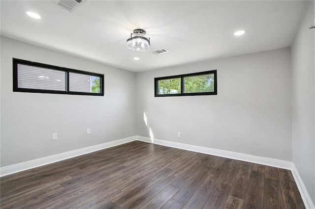 spare room with dark wood-type flooring