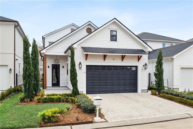 modern inspired farmhouse featuring a garage