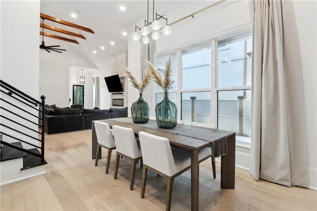 dining area featuring vaulted ceiling with beams, light hardwood / wood-style flooring, and ceiling fan