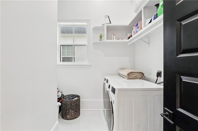 laundry area featuring tile patterned flooring and separate washer and dryer