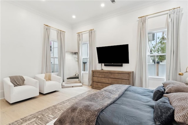 bedroom featuring light hardwood / wood-style floors and ornamental molding