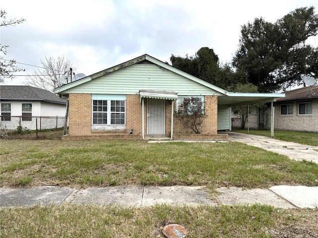 view of front facade with a front lawn and a carport