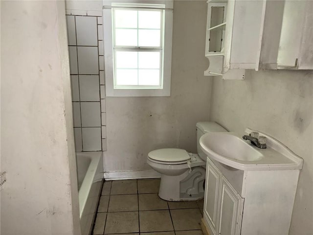 bathroom featuring tile patterned floors, a bathing tub, toilet, and vanity