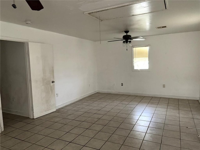 tiled spare room with ceiling fan