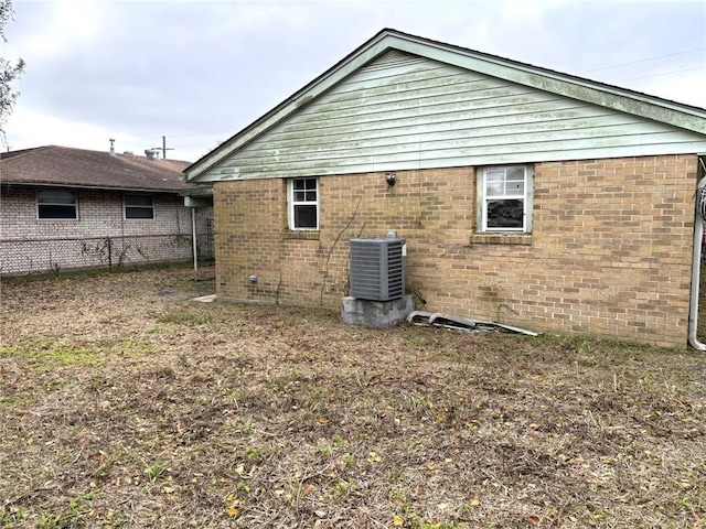 view of side of home with central air condition unit