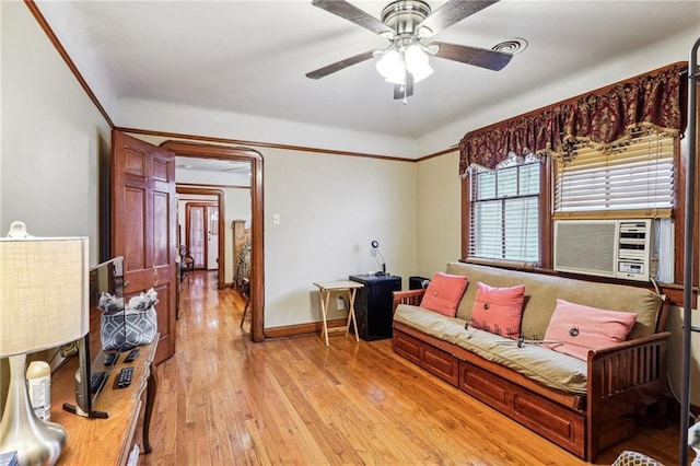 living room with light hardwood / wood-style flooring, ceiling fan, and cooling unit