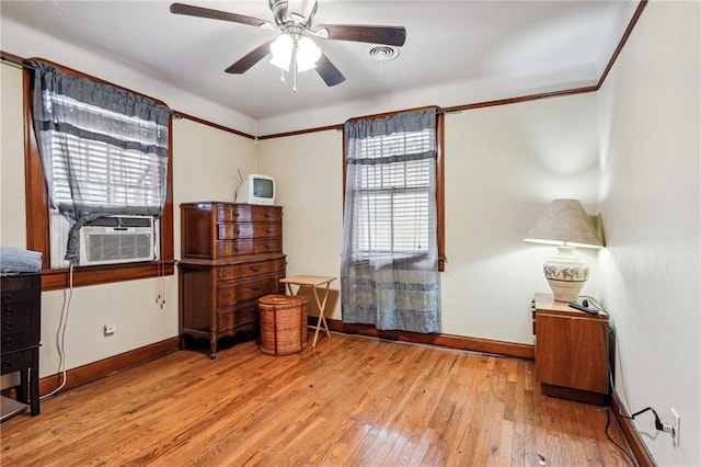 misc room featuring light hardwood / wood-style flooring, ceiling fan, and cooling unit