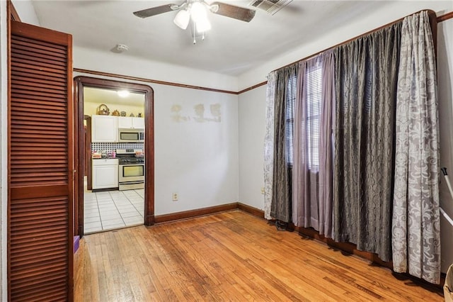 interior space featuring light hardwood / wood-style flooring and ceiling fan