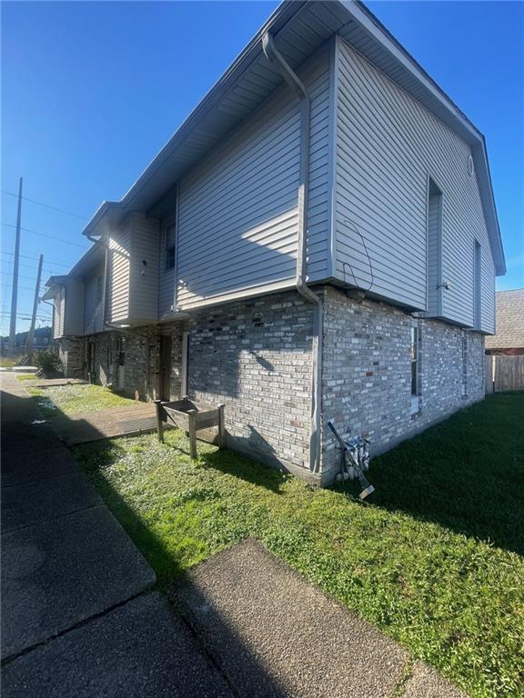 view of property exterior featuring a lawn