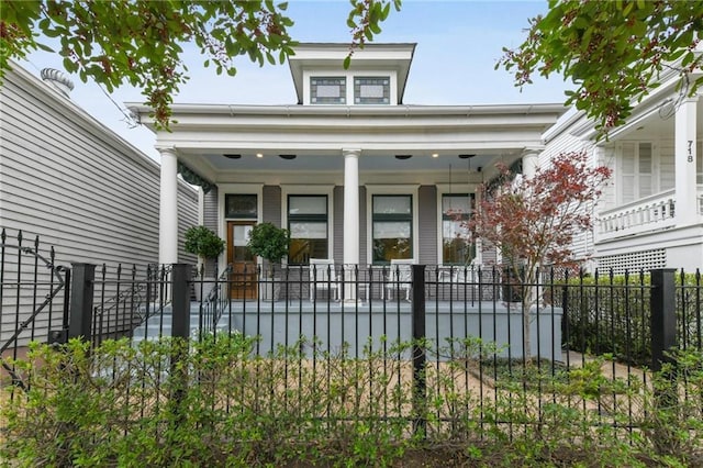 view of front of house with a porch and a fenced front yard