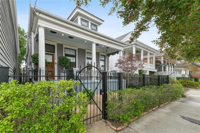 view of front of property featuring a porch, a gate, and a fenced front yard