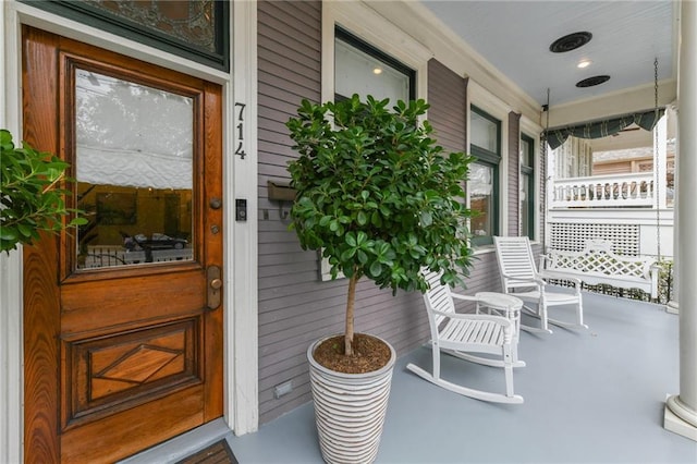 view of exterior entry featuring a porch