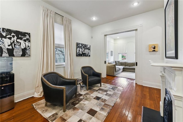 sitting room featuring a healthy amount of sunlight and dark hardwood / wood-style floors