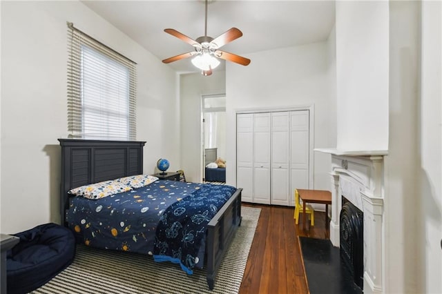 bedroom featuring dark hardwood / wood-style flooring, a closet, and ceiling fan