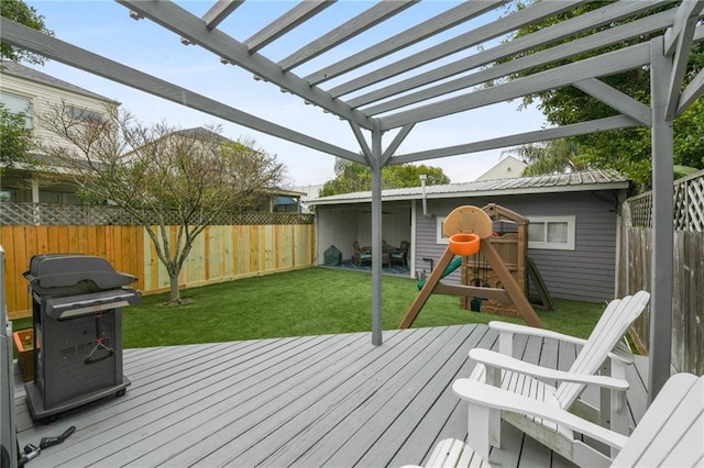 deck featuring a playground, a pergola, a yard, and grilling area