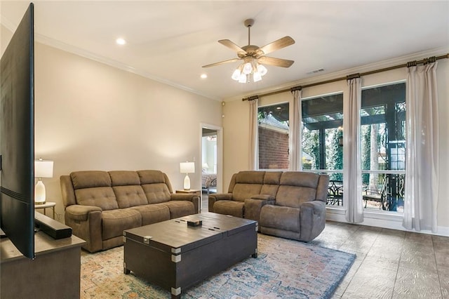 living room with wood-type flooring, ceiling fan, and ornamental molding