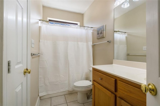 bathroom with tile patterned flooring, vanity, and toilet