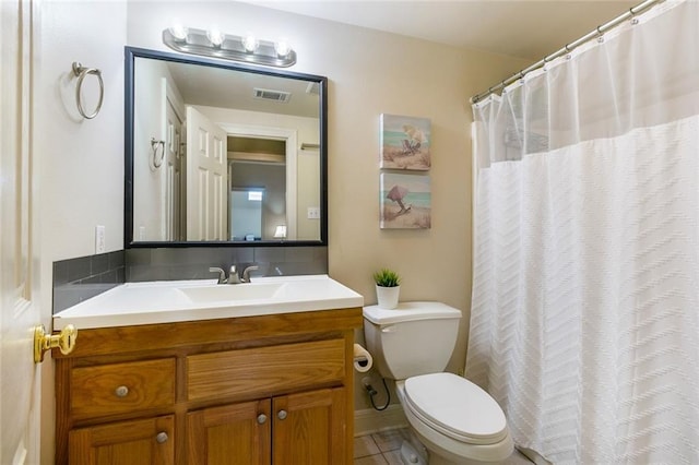 bathroom with tile patterned floors, vanity, and toilet