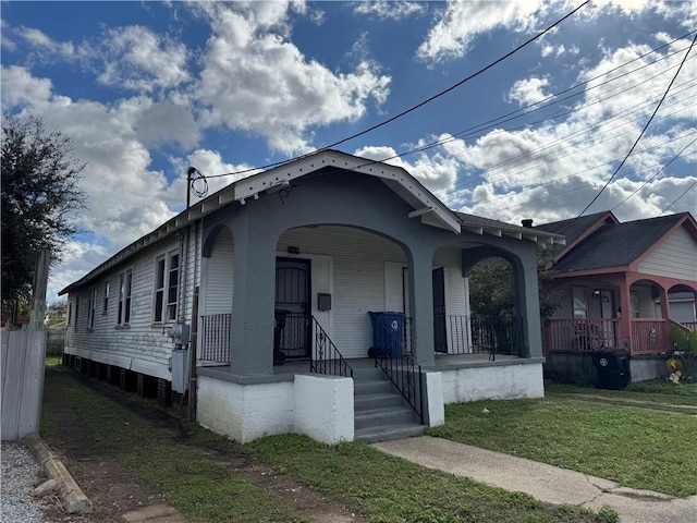 bungalow-style house with a porch and a front lawn