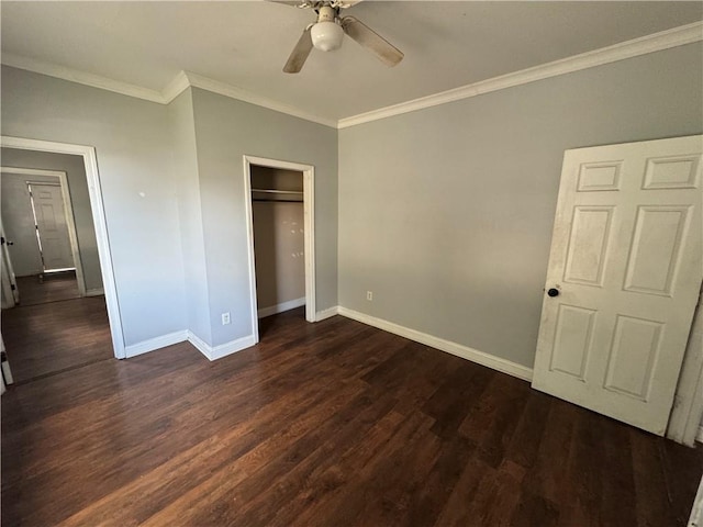 unfurnished bedroom with a closet, dark hardwood / wood-style floors, ceiling fan, and crown molding