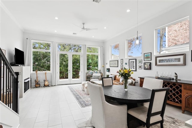 dining space with ceiling fan, crown molding, and french doors