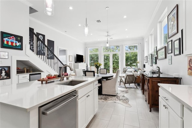 kitchen featuring white cabinetry, dishwasher, ceiling fan, and pendant lighting