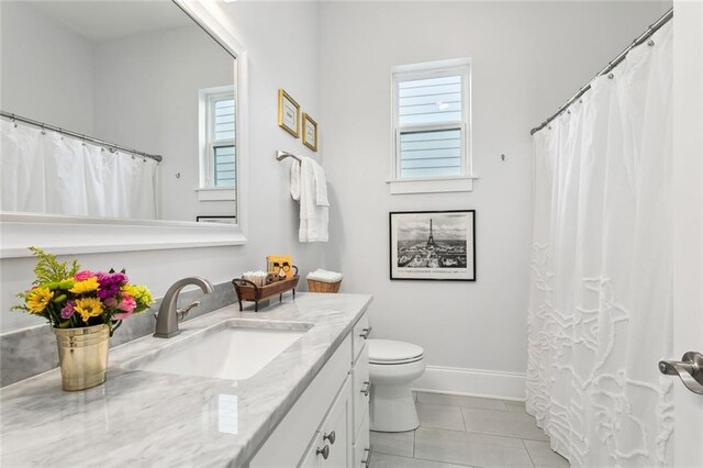 bathroom featuring toilet, vanity, and tile patterned floors