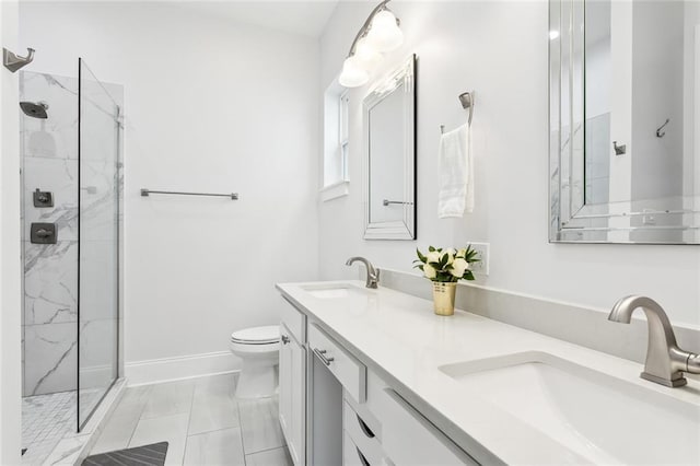 bathroom with tile patterned flooring, toilet, vanity, and tiled shower