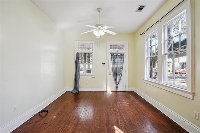 unfurnished room featuring ceiling fan and dark hardwood / wood-style flooring