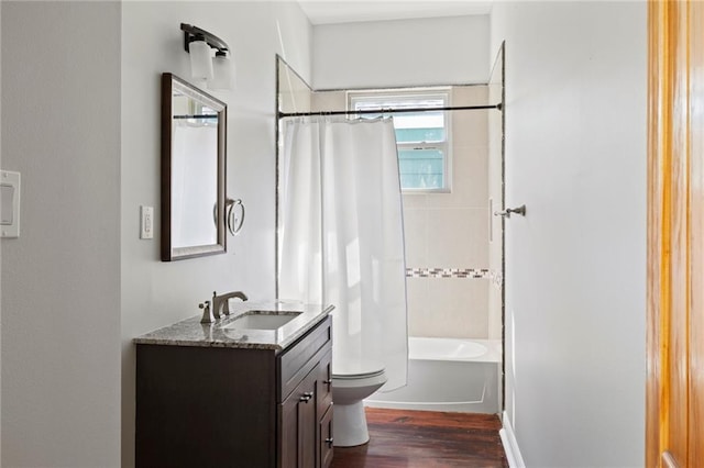 full bathroom featuring shower / bathtub combination with curtain, hardwood / wood-style floors, vanity, and toilet