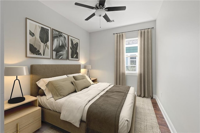 bedroom with ceiling fan and dark hardwood / wood-style flooring