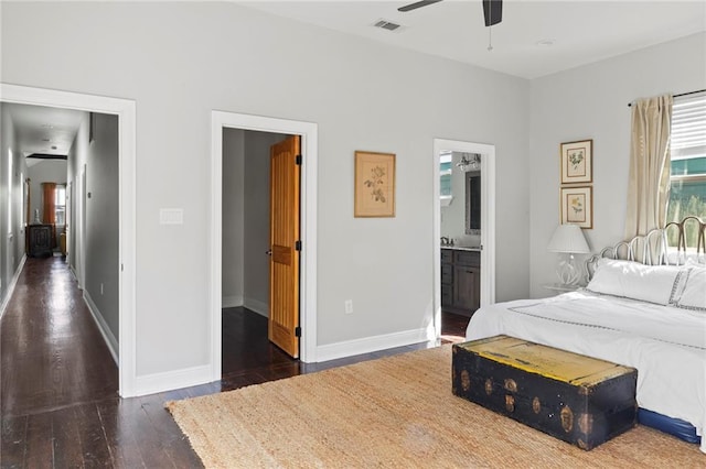 bedroom featuring connected bathroom, ceiling fan, and dark wood-type flooring