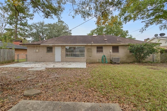 back of house featuring a patio, a yard, and central AC