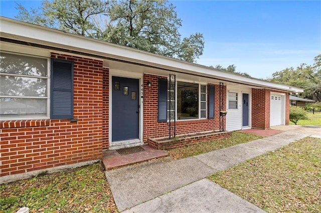 single story home featuring a porch and a garage