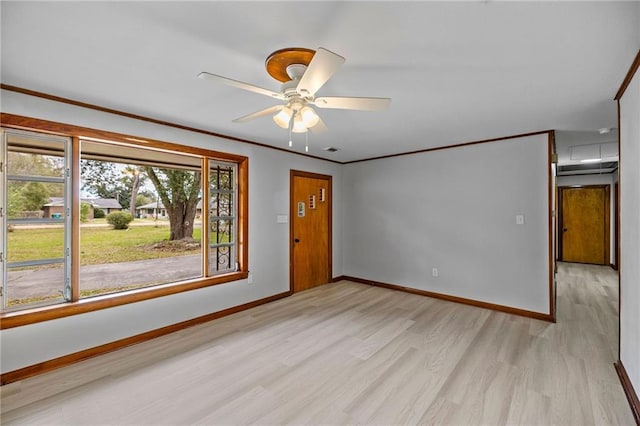 spare room with ceiling fan, crown molding, and light hardwood / wood-style flooring