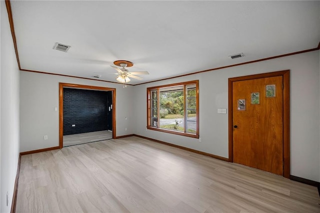 interior space featuring light wood-type flooring, ceiling fan, and ornamental molding